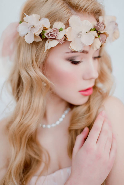 picture of young blonde woman wearing wreath of flowers, spring tender and romantic portrait, fashion retouched shot - Фото, зображення