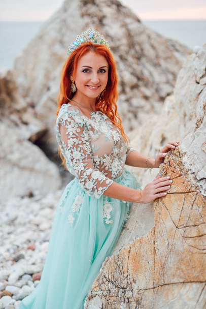young woman in a luxurious dress stands on the shore of the Adriatic Sea - Fotó, kép