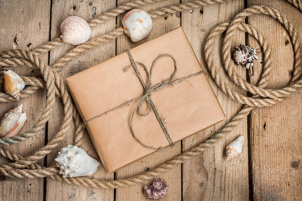 Vintage gift box  and rope on wooden background - Fotó, kép