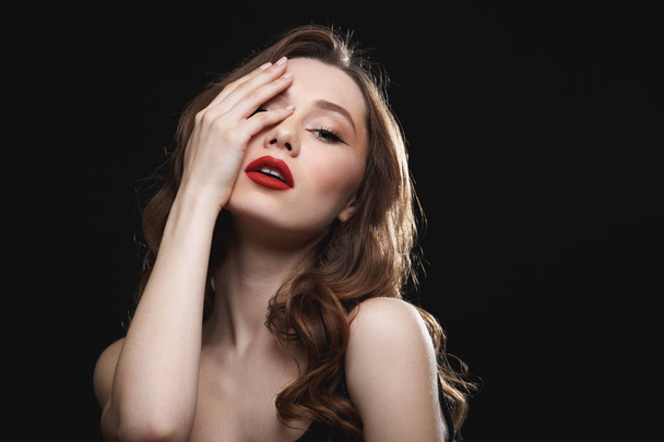 Sensual gorgeous young woman with red lips touching her face - Foto, imagen
