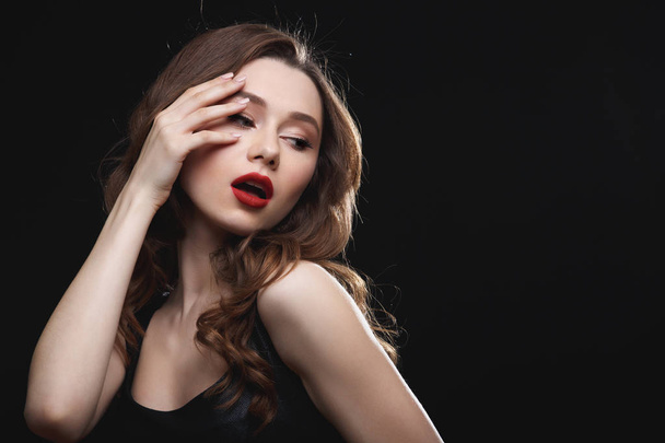 Seductive attractive young woman with red lips standing and posing - 写真・画像