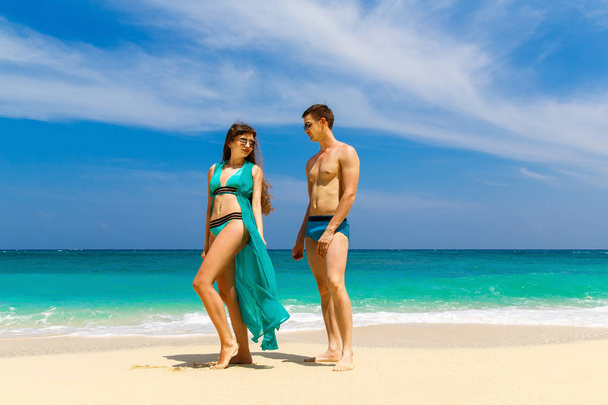 Young loving couple having fun on tropical beach. Summer vacatio - Photo, Image