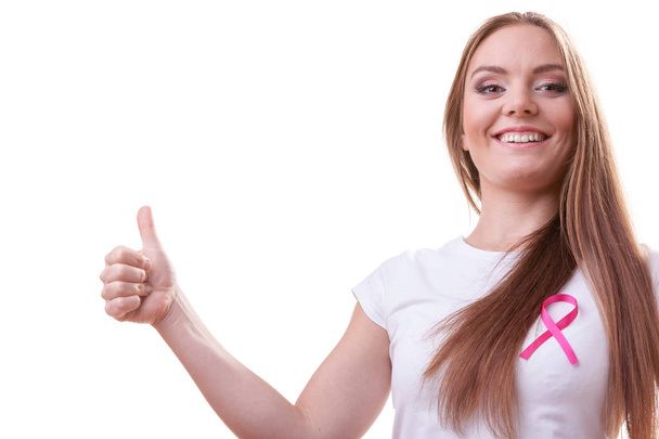 woman pink cancer ribbon on chest making thumb up - Фото, изображение