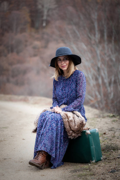 pretty girl with vintage case on a dirtroad - Foto, Imagen