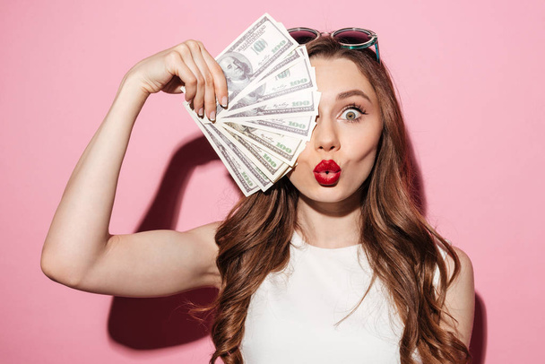 Pretty young brunette lady holding money - Fotografie, Obrázek