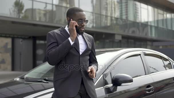Successful employee talking on phone to boss, telling about business meeting - Felvétel, videó