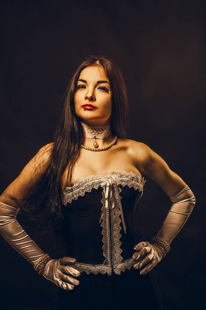 Young countess over dark background - Foto, imagen