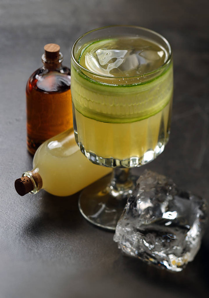 Cocktail with cucumber and two bottles - Foto, Imagem