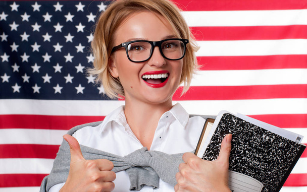 Student is learning English as a foreign language on American flag  background - Photo, Image