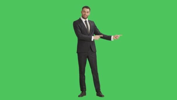 Long Shot of a Handsome Smiling  Businessman Making Finger Guns/ Presenting Gesture. Background is Green Screen. - Footage, Video