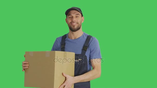 Mid Shot of a Handsome Loader Holding Cardboard Box. Shot with Green Screen Background. - Metraje, vídeo