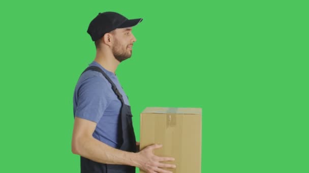 Profile Mid Shot of a Handsome Loader Handing in Cardboard Box. Shot with Green Screen Background. - Metraje, vídeo