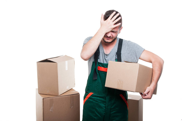 Mover man holding cardboard box gesturing mistake - Photo, Image
