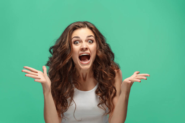 Portrait of young woman with shocked facial expression - Photo, image