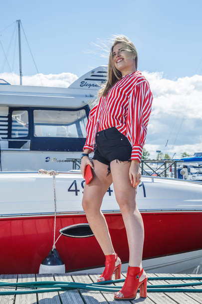 young woman posing near yacht - 写真・画像