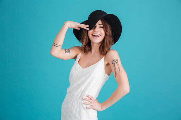 Portrait of a happy smiling girl wearing hat and posing - Фото, зображення