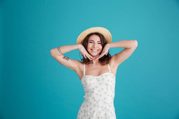 Portrait of a happy smiling girl wearing hat and posing - Photo, image