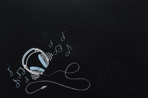 headphones with musical notes drawn on chalkboard - Photo, Image
