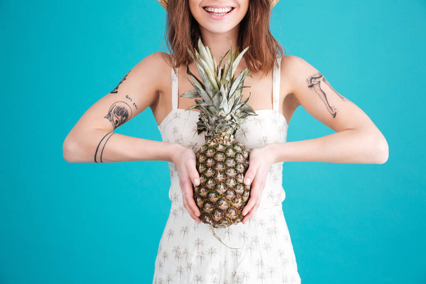 Cropped image of happy young lady holding pineapple. - Foto, Imagem
