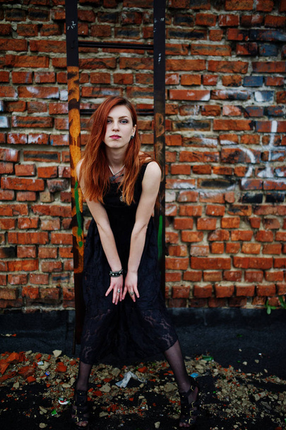 Red haired punk girl wear on black dress at the roof against bri - Фото, зображення