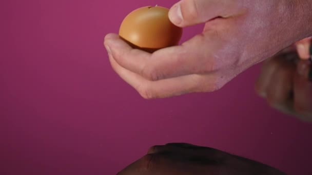 Broken egg, a knife with black handle - Materiał filmowy, wideo