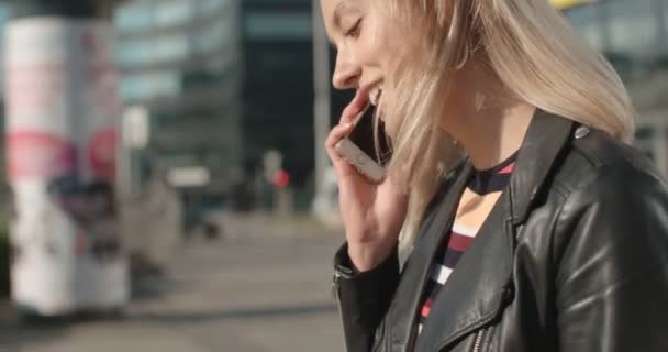 Young caucasian woman using phone in a city. - Video