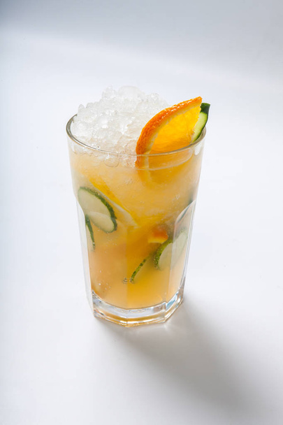 glass with orange cucumber refreshing drink, rustic style, selective focus - Foto, Imagen