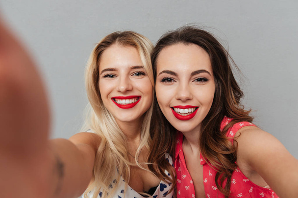 Pretty happy young women make selfie. - Фото, зображення
