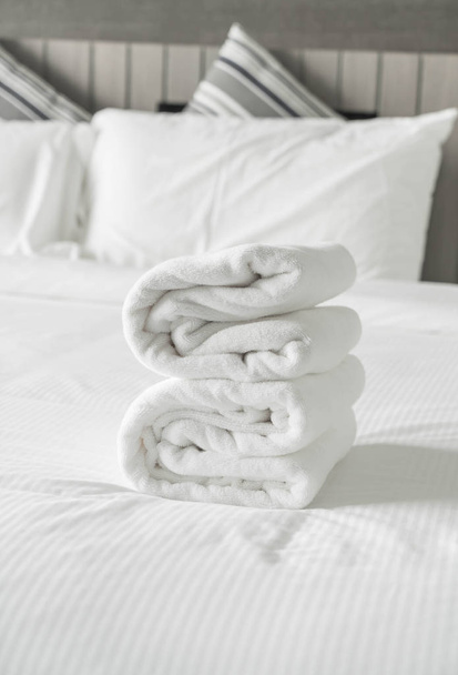 White towel on bed decoration in bedroom interior  - Фото, изображение
