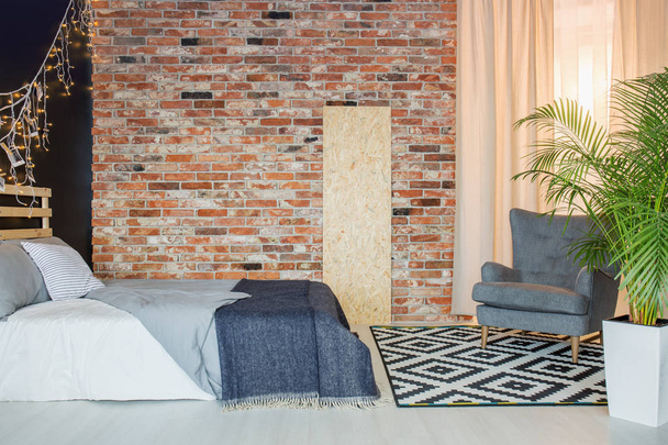 Bedroom with brick wall - 写真・画像