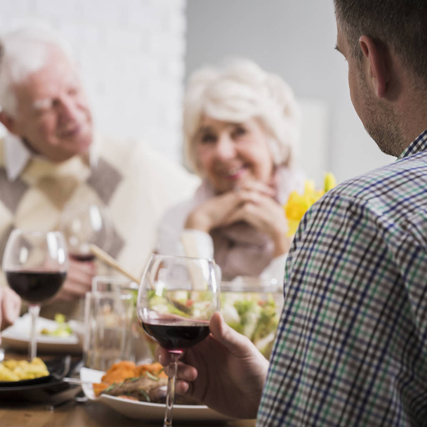 Mature and young marriages during family dinner - Photo, Image