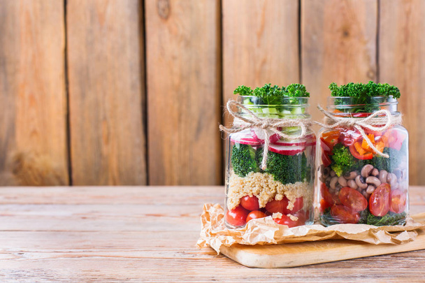 Salada vegan saudável em um frasco de pedreiro com quinoa
 - Foto, Imagem