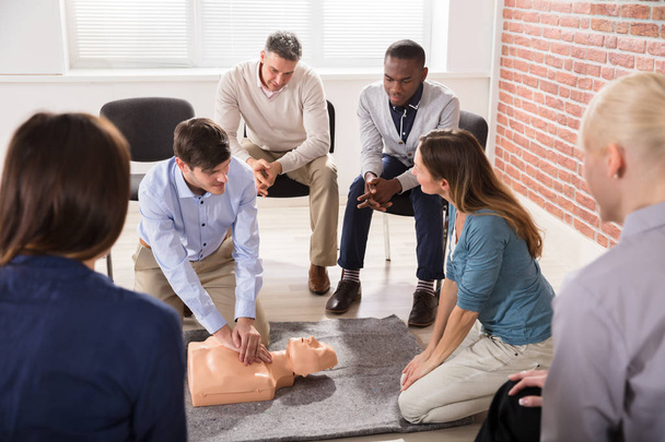 Young Male Instructor Showing CPR Training On Dummy To His Student - Photo, Image