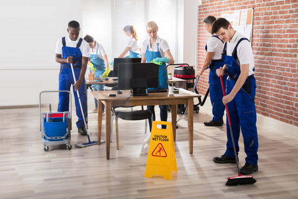 Group Of Janitors In Uniform Cleaning The Office With Cleaning Equipments - Fotó, kép