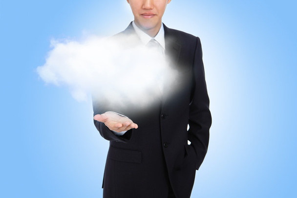 Geschäftsmann hält weiße Wolke in der Hand - Foto, Bild
