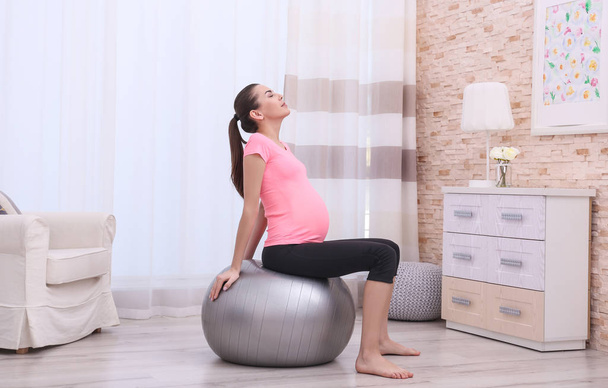 pregnant woman doing exercise - Fotó, kép