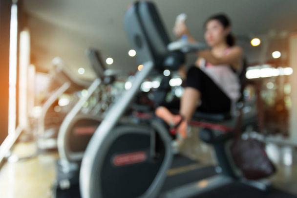 blurred woman cycling burn fat on bicycle cardio machine - Foto, Bild