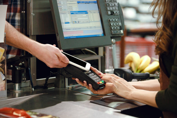 Cropped image of cashier woman create payment with phone app. - Fotoğraf, Görsel