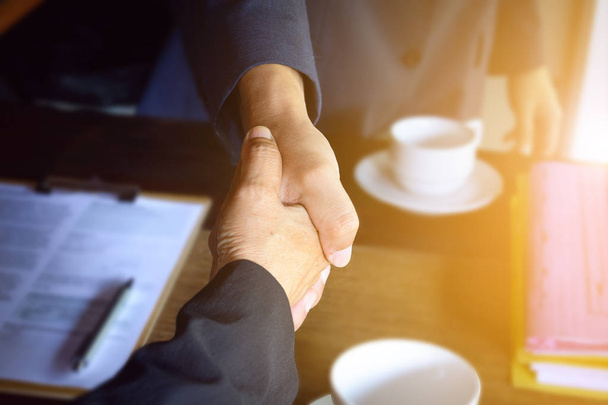 Businessmen shake hands with contract - Photo, Image