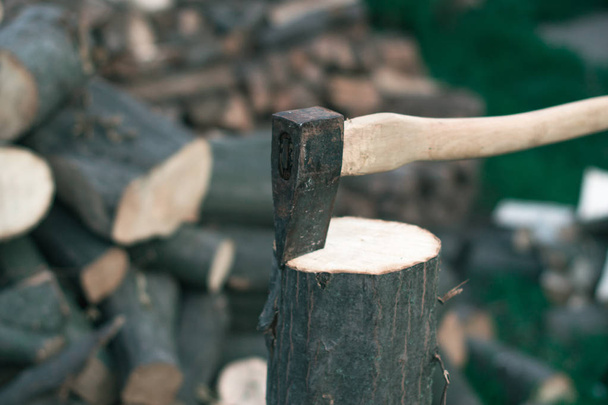 Felling firewood with an ax with a blurred background. - Photo, Image