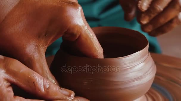 Creating a clay pot.Gonchar.Potter.A turner.Workshop of clay.Clay on the device.Master.Hands working on pottery wheel, shaping a clay pot - Footage, Video