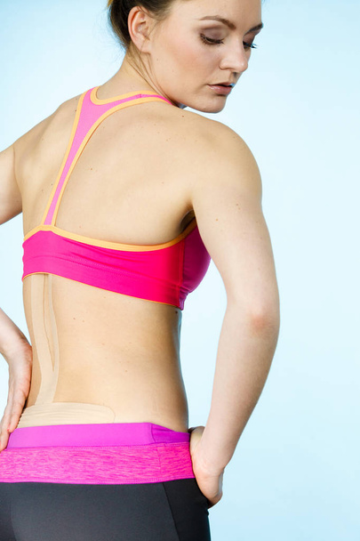 Woman with medical kinesio taping on back - Foto, Imagem