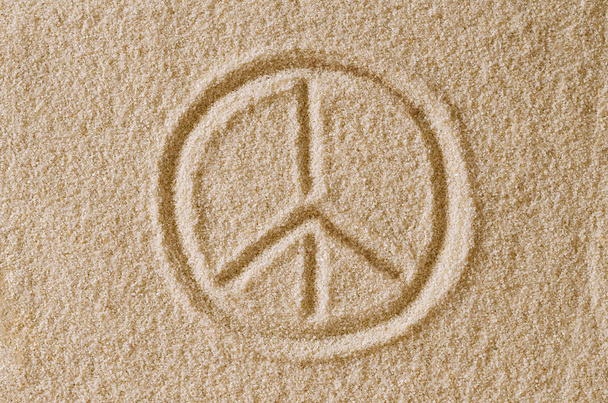 Peace Sign drawn in sand macro photo - Photo, Image