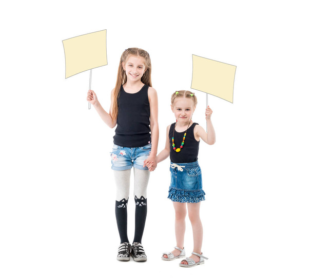 sibling sisters holding hands, blank posters - Foto, imagen