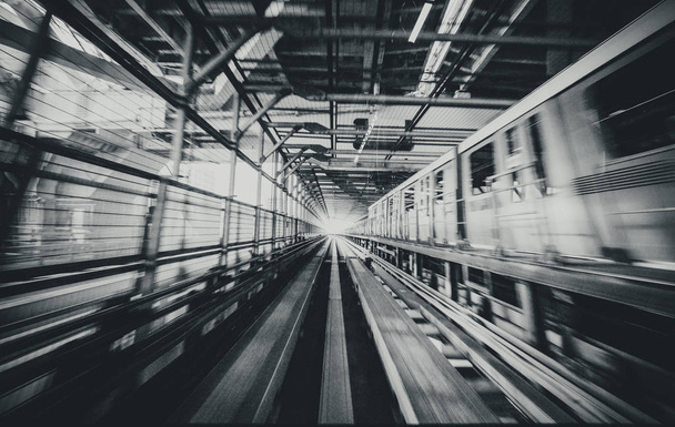 Train moving on city rail with motion blur - 写真・画像