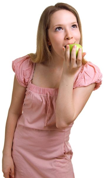 Beautiful girl eats a green apple - Photo, Image