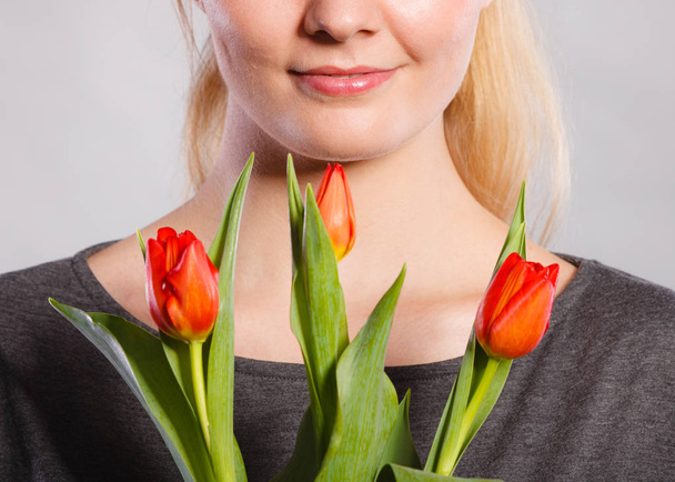 Smiling female holding boquet. - Фото, изображение