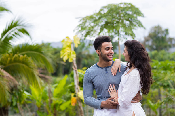 Happy Latin Man Embracing Woman, Young Couple Over Green Tropical Rain Forest Landscape - Foto, immagini