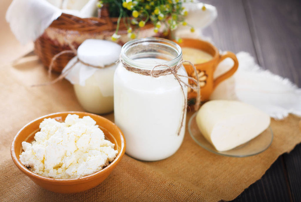 Assorted dairy products milk, yogurt, cottage cheese, sour cream. Rustic still life. - Photo, Image