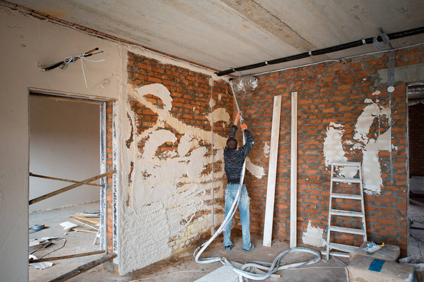 Plastering Walls with a plastering pump Machine - Photo, Image